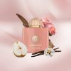 Amouage Guidance Eau de Parfum bottle styled with pear, vanilla, rose, and woody fragrance notes on a soft pink backdrop