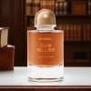Byredo Cuir Sellier Extrait de Parfum bottle on a table with warm library background and luxury leather-inspired atmosphere