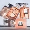 Three COCO MADEMOISELLE Eau de Parfum bottles by CHANEL arranged together in an artistic luxury display with soft pink and gold tones.