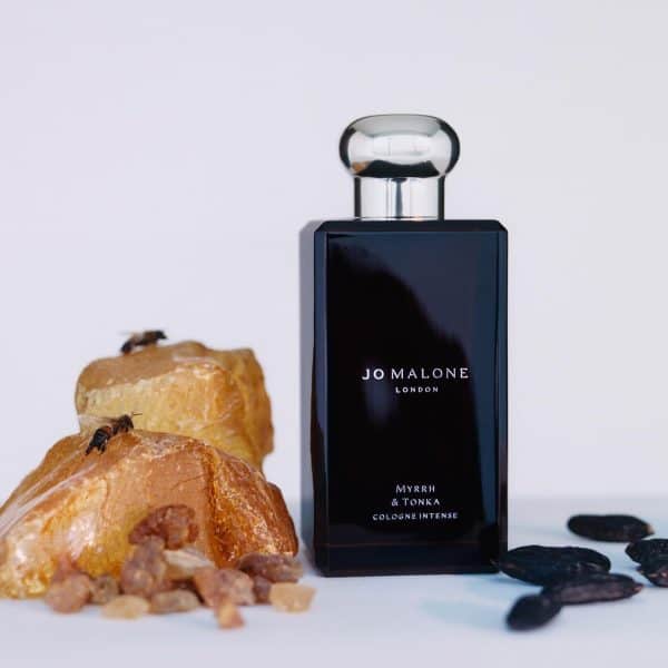 Jo Malone Myrrh & Tonka Cologne bottle with spices and coffee beans.