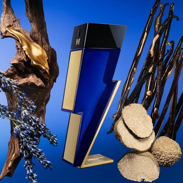 Stylish blue and gold perfume bottle with artistic natural elements.